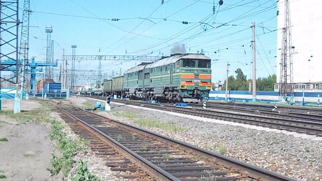 Тепловоз 2ТЭ116-1001 с составом из фитинговых платформ.