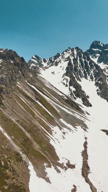 Захватывающий вид с воздуха на заснеженные горы.